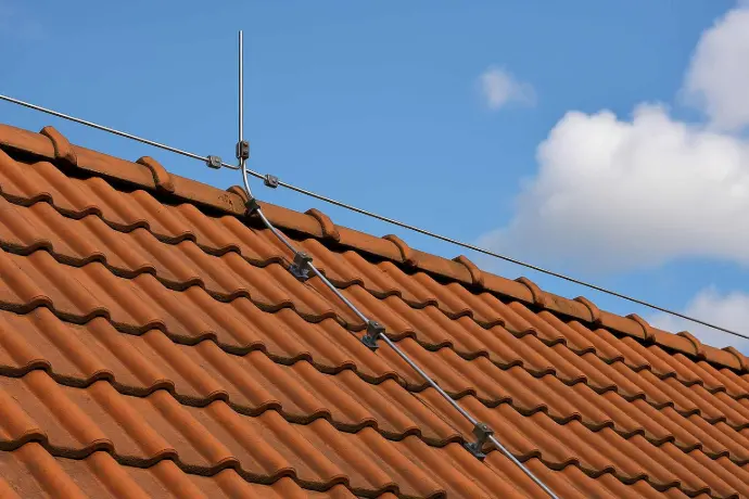 Blitzschutz auf Ziegeldach in Hall in Tirol – Fangstange und Ableitungsleiter für Gebäudeschutz